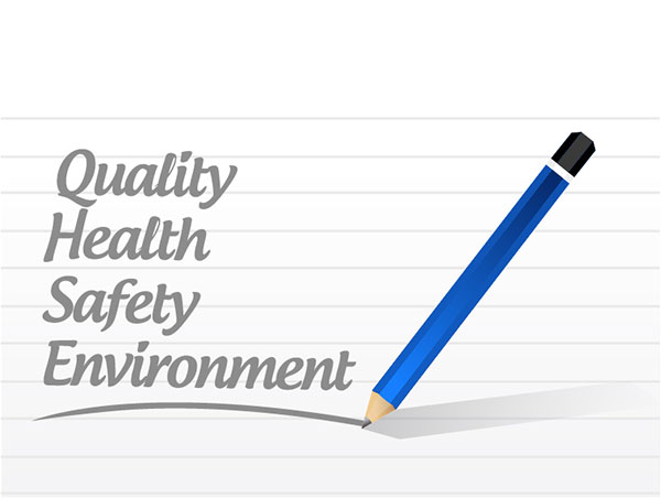 A page of notepad on which quality, health, safety and environment from pencil