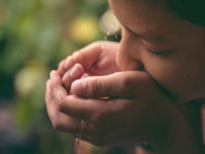 Girl drinking water from tap